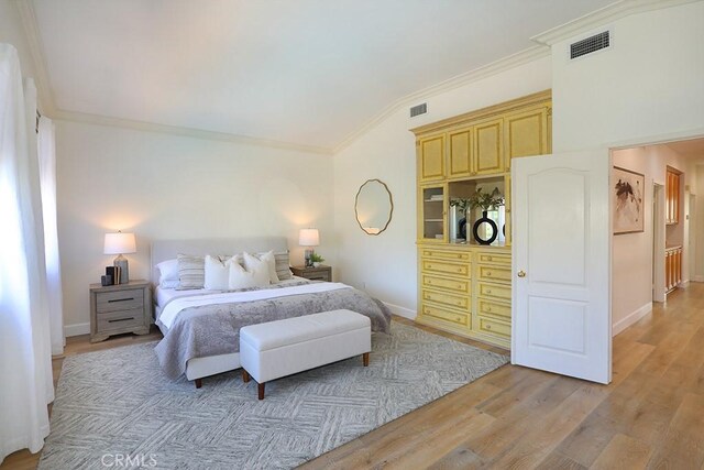 1019 N Sonora Cir, Orange, CA 92869 - bedroom with crown molding, light wood finished floors, and vaulted ceiling