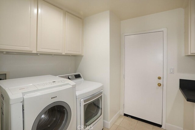 1019 N Sonora Cir, Orange, CA 92869 - washroom featuring cabinet space, washer and clothes dryer, and light tile patterned flooring