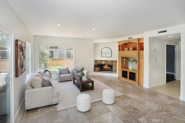 1019 N Sonora Cir, Orange, CA 92869 - living room featuring a fireplace, recessed lighting, and light stone finish floors