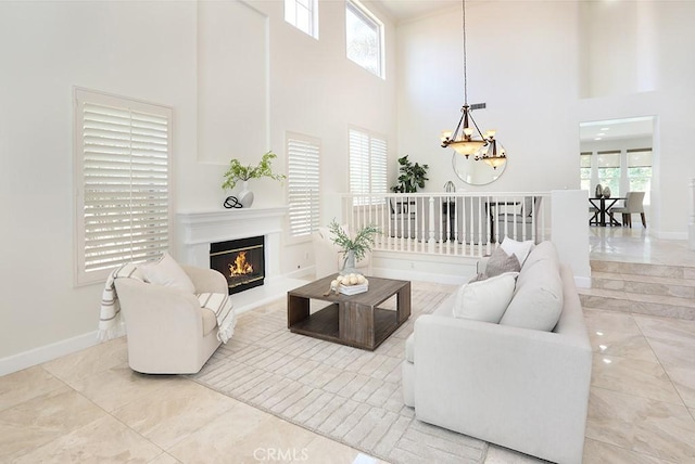 1019 N Sonora Cir, Orange, CA 92869 - living area with a chandelier, a towering ceiling, and a warm lit fireplace