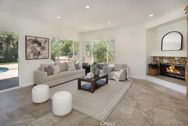 1019 N Sonora Cir, Orange, CA 92869 - living room featuring recessed lighting, a stone fireplace, and stone finish floors