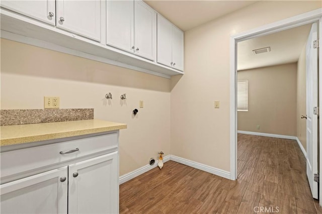 14230 Calahan St, Panorama City, CA 91402 - laundry area with gas dryer hookup, wood finished floors, cabinet space, and baseboards