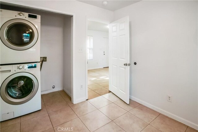 3504 Minnesota Trl, Frazier Park, CA 93225 - laundry area with estacked washer and dryer, light tile patterned flooring, and baseboards