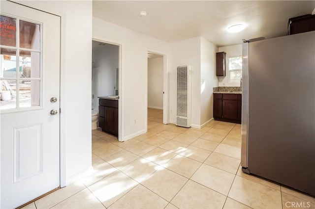 3504 Minnesota Trl, Frazier Park, CA 93225 - kitchen featuring freestanding refrigerator, a heating unit, light tile patterned flooring, light stone countertops, and baseboards