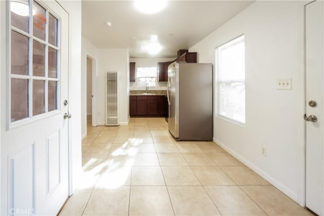 3504 Minnesota Trl, Frazier Park, CA 93225 - kitchen featuring freestanding refrigerator, a heating unit, light tile patterned flooring, light countertops, and dark brown cabinets