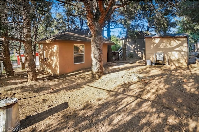 3504 Minnesota Trl, Frazier Park, CA 93225 - view of home's exterior with stucco siding and an outdoor structure