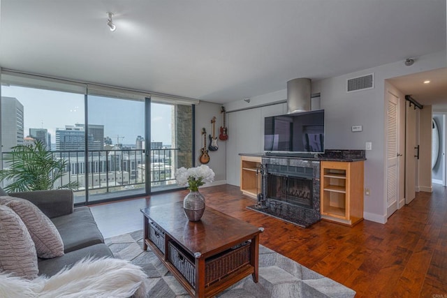 1333 8th Ave Unit 905, San Diego, CA 92101 - living area with a high end fireplace, dark wood-style floors, and baseboards