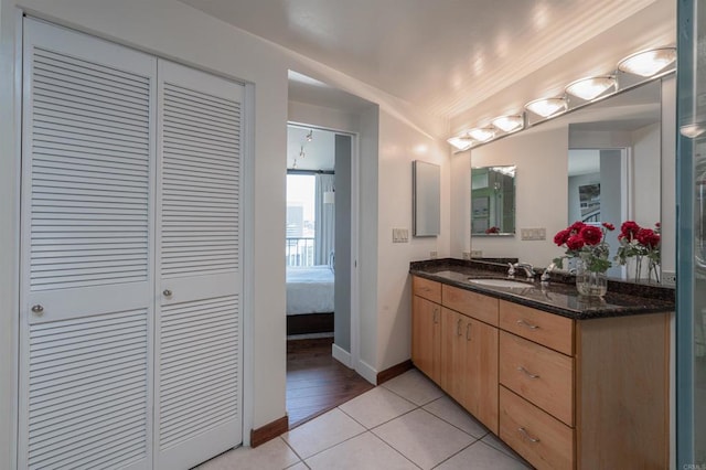 1333 8th Ave Unit 905, San Diego, CA 92101 - bathroom with a closet, vanity, tile patterned floors, and baseboards