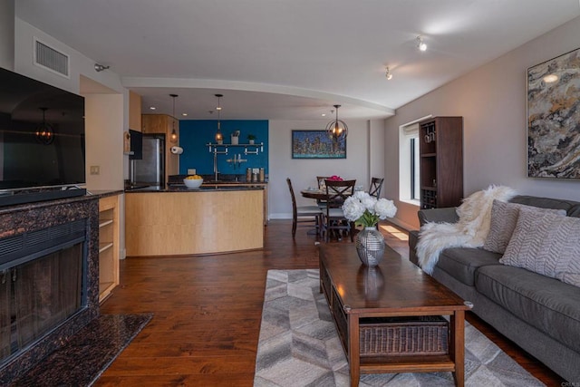 1333 8th Ave Unit 905, San Diego, CA 92101 - living room with dark wood-style flooring, a chandelier, a premium fireplace, and baseboards