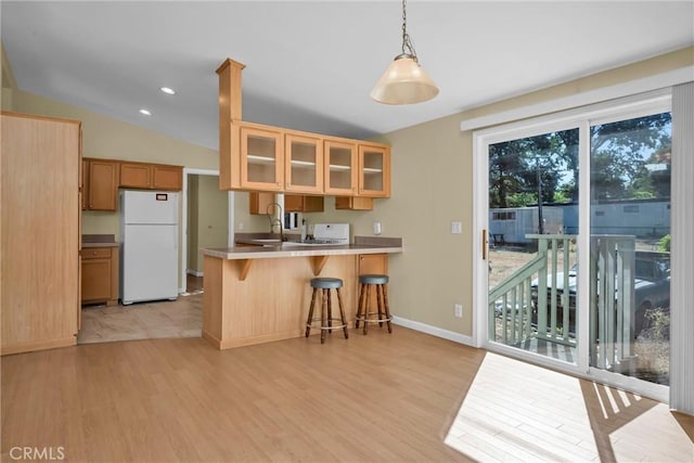 16410 Tish A Tang Rd, Lower Lake, CA 95457 - kitchen with freestanding refrigerator, light wood-type flooring, glass insert cabinets, a peninsula, and baseboards