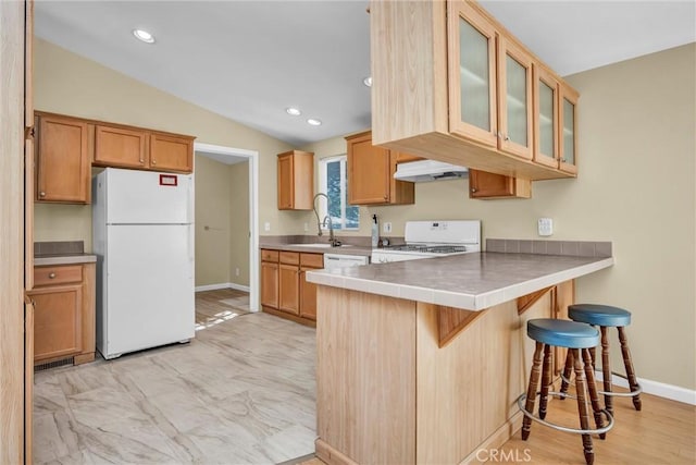 16410 Tish A Tang Rd, Lower Lake, CA 95457 - kitchen with white appliances, under cabinet range hood, a breakfast bar, a peninsula, and vaulted ceiling