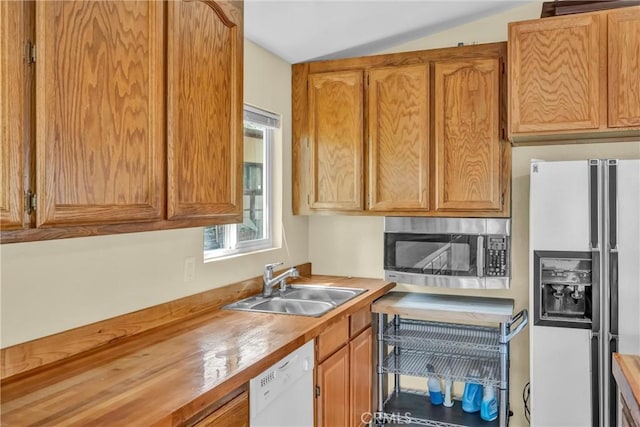 16410 Tish A Tang Rd, Lower Lake, CA 95457 - kitchen with white appliances, a sink, lofted ceiling, and brown cabinetry