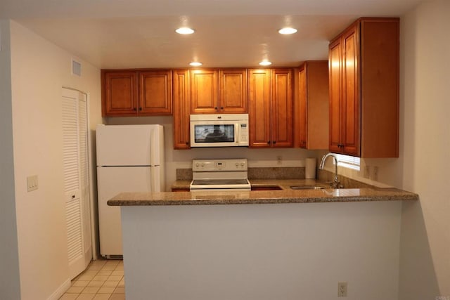 11215 Avenida De Los Lobos Unit F, Rancho Bernardo San Diego, CA 92127 - kitchen featuring white appliances, a sink, recessed lighting, stone counters, and a peninsula