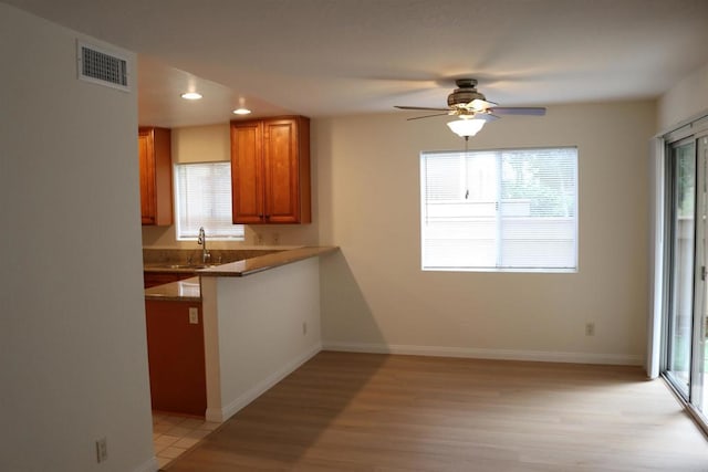 11215 Avenida De Los Lobos Unit F, Rancho Bernardo San Diego, CA 92127 - kitchen with brown cabinets, plenty of natural light, a sink, and recessed lighting