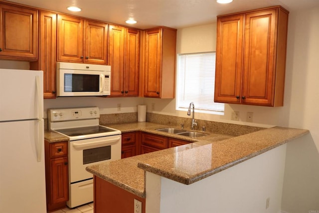 11215 Avenida De Los Lobos Unit F, Rancho Bernardo San Diego, CA 92127 - kitchen with white appliances, a sink, a peninsula, recessed lighting, and brown cabinetry