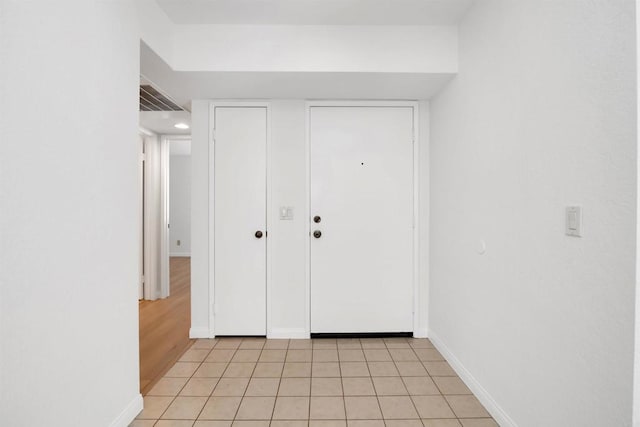 11215 Avenida De Los Lobos Unit F, Rancho Bernardo San Diego, CA 92127 - entrance foyer with baseboards and light tile patterned floors
