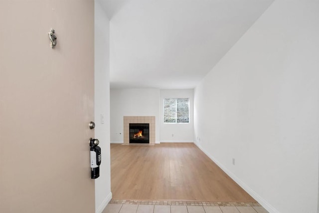 11215 Avenida De Los Lobos Unit F, Rancho Bernardo San Diego, CA 92127 - unfurnished living room featuring a tiled fireplace and light tile patterned floors
