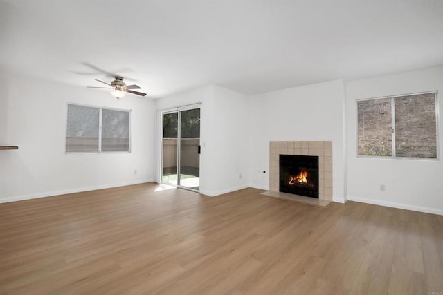 11215 Avenida De Los Lobos Unit F, Rancho Bernardo San Diego, CA 92127 - unfurnished living room with ceiling fan, light wood finished floors, and a fireplace