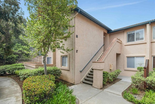 11215 Avenida De Los Lobos Unit F, Rancho Bernardo San Diego, CA 92127 - view of home's exterior featuring stucco siding and stairway