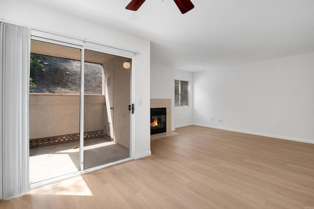 11215 Avenida De Los Lobos Unit F, Rancho Bernardo San Diego, CA 92127 - unfurnished living room with ceiling fan, wood finished floors, and a fireplace