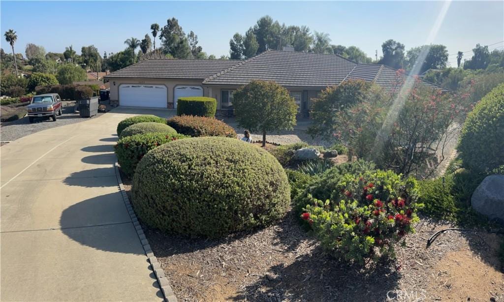 1103 Mcdonald Mdws, Fallbrook, CA 92028 - view of front of property featuring a tile roof, driveway, a garage, and stucco siding