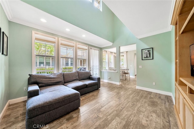 25 Ellsworth St Unit 11, Ladera Ranch, CA 92694 - living room featuring crown molding, plenty of natural light, baseboards, wood finished floors, and recessed lighting