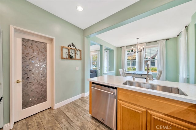 25 Ellsworth St Unit 11, Ladera Ranch, CA 92694 - kitchen featuring dishwasher, a sink, a chandelier, light wood-style floors, and baseboards