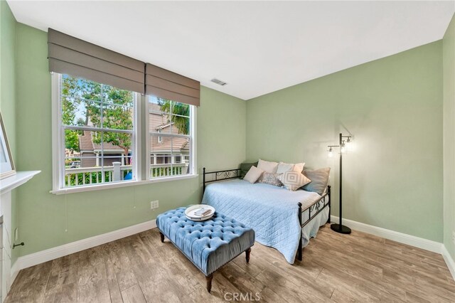25 Ellsworth St Unit 11, Ladera Ranch, CA 92694 - bedroom with baseboards and wood finished floors