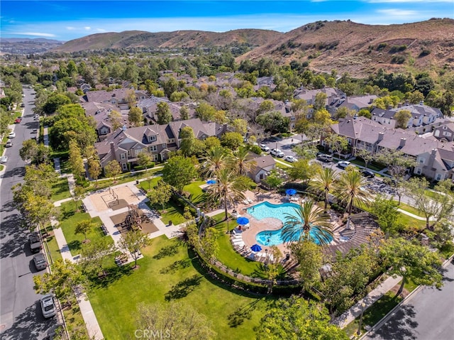 25 Ellsworth St Unit 11, Ladera Ranch, CA 92694 - view of property location featuring a pool, a mountain backdrop, and nearby suburban area
