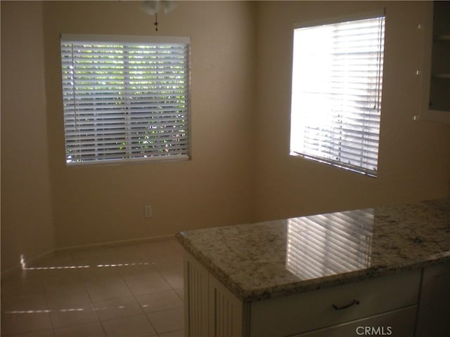 28265 La Bajada, Laguna Niguel, CA 92677 - kitchen featuring healthy amount of natural light, tile patterned flooring, baseboards, and light stone counters