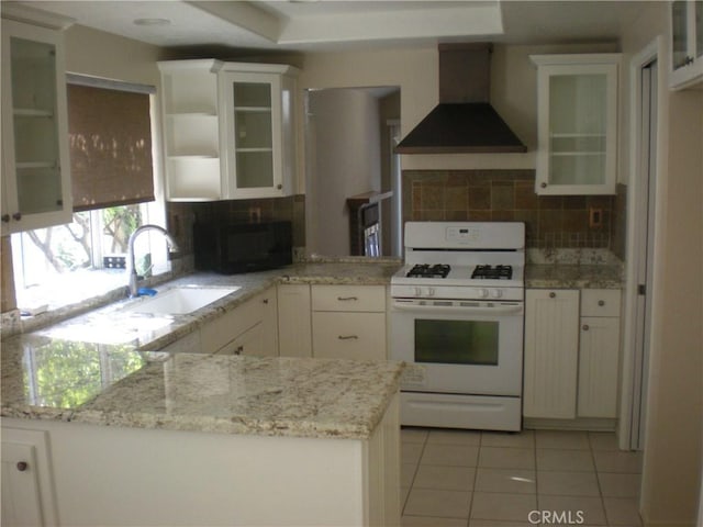 28265 La Bajada, Laguna Niguel, CA 92677 - kitchen featuring wall chimney exhaust hood, gas range gas stove, black microwave, light tile patterned floors, and white cabinetry