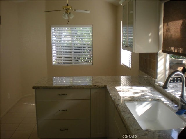 28265 La Bajada, Laguna Niguel, CA 92677 - kitchen featuring a sink, a ceiling fan, tile patterned floors, and light stone countertops