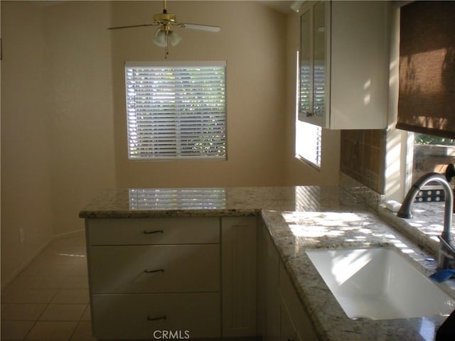 28265 La Bajada, Laguna Niguel, CA 92677 - kitchen with a ceiling fan, tile patterned flooring, and light stone counters