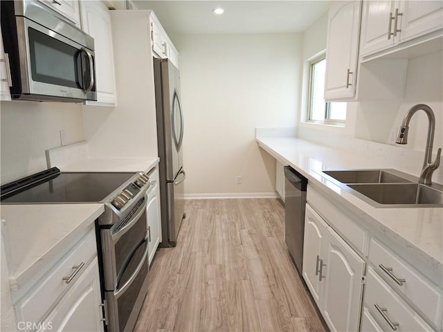 4734 Park Granada Unit 238, Calabasas, CA 91302 - kitchen featuring appliances with stainless steel finishes, a sink, light wood-type flooring, white cabinetry, and baseboards