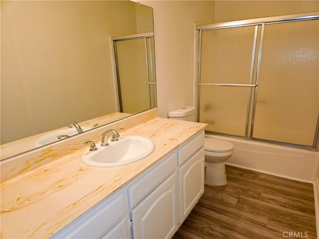 4734 Park Granada Unit 238, Calabasas, CA 91302 - bathroom with toilet, vanity, wood finished floors, and shower / bath combination with glass door