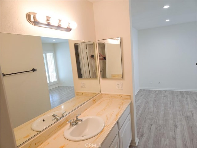 4734 Park Granada Unit 238, Calabasas, CA 91302 - bathroom with vanity, wood finished floors, recessed lighting, and baseboards