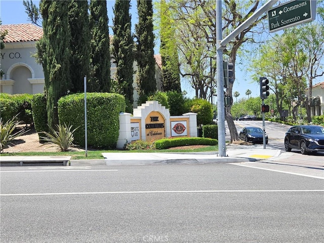 4734 Park Granada Unit 238, Calabasas, CA 91302 - view of asphalt road with curbs, sidewalks, traffic lights, and street lights