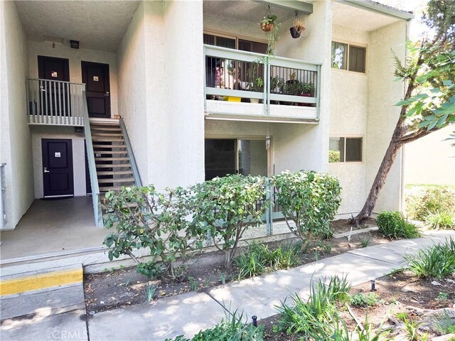 4734 Park Granada Unit 238, Calabasas, CA 91302 - view of exterior entry with stucco siding and a balcony