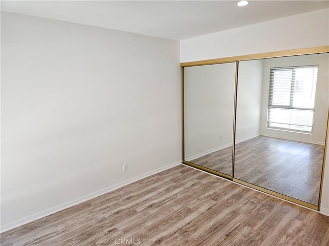 4734 Park Granada Unit 238, Calabasas, CA 91302 - unfurnished bedroom featuring light wood finished floors, a closet, baseboards, and recessed lighting