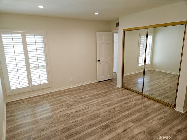 4734 Park Granada Unit 238, Calabasas, CA 91302 - unfurnished bedroom featuring wood finished floors, a closet, baseboards, and recessed lighting