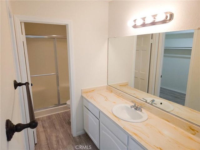 4734 Park Granada Unit 238, Calabasas, CA 91302 - bathroom with wood finished floors, vanity, a stall shower, toilet, and a walk in closet