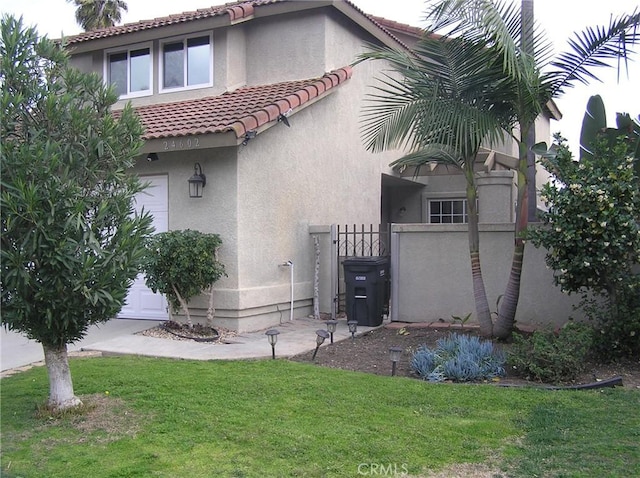 24602 Via Del Oro, Laguna Niguel, CA 92677 - back of property with a tiled roof, stucco siding, and a gate