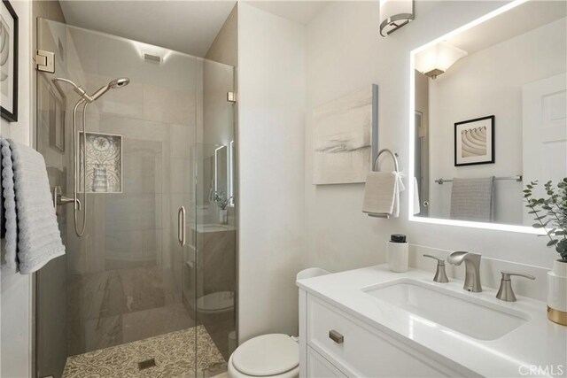 27170 Arrow Point Trl, Corona, CA 92883 - bathroom featuring toilet, a shower stall, vanity, and marble look tile flooring