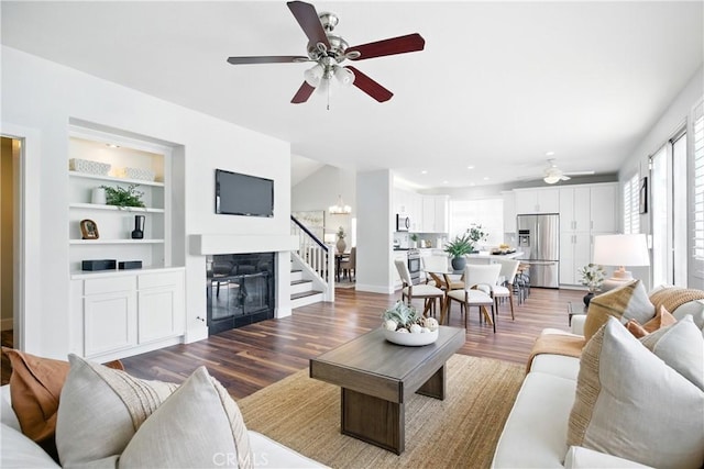 27170 Arrow Point Trl, Corona, CA 92883 - living room featuring a ceiling fan, a glass covered fireplace, wood finished floors, built in shelves, and recessed lighting