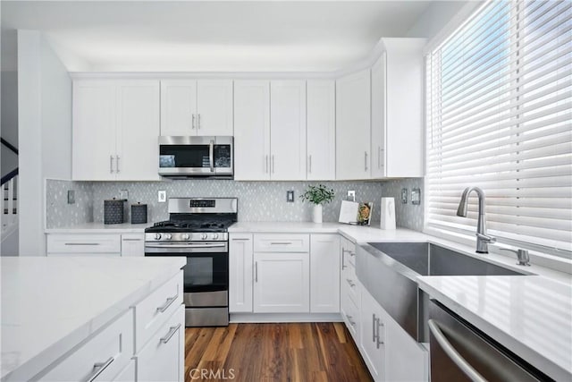 27170 Arrow Point Trl, Corona, CA 92883 - kitchen with stainless steel appliances, healthy amount of natural light, light countertops, and white cabinets