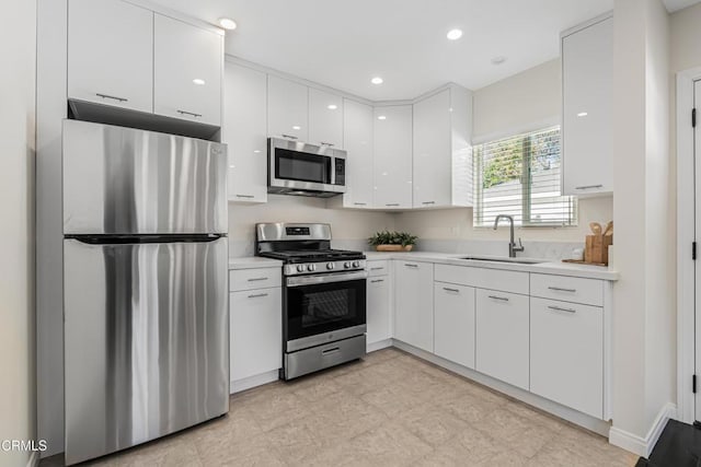 15233 Camarillo St, Sherman Oaks, CA 91403 - kitchen with stainless steel appliances, a sink, white cabinets, light countertops, and recessed lighting