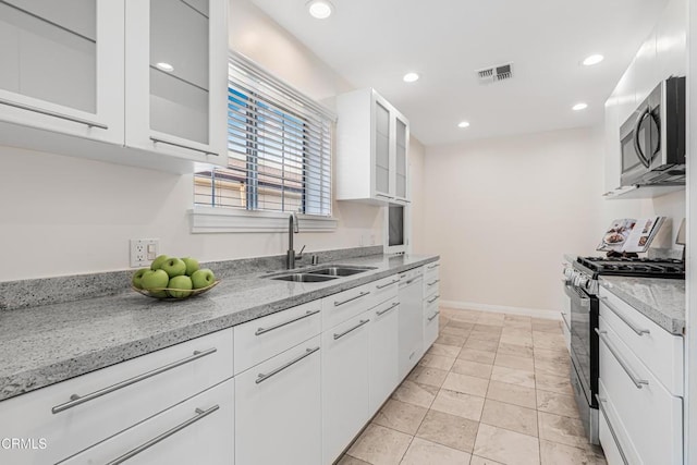 15233 Camarillo St, Sherman Oaks, CA 91403 - kitchen with stainless steel appliances, a sink, white cabinetry, recessed lighting, and light stone counters