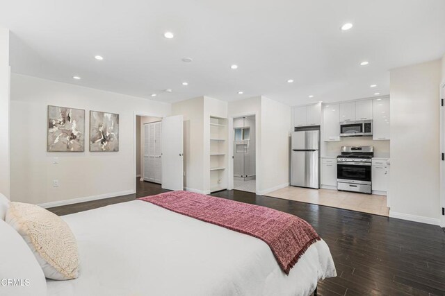 15233 Camarillo St, Sherman Oaks, CA 91403 - bedroom with freestanding refrigerator, baseboards, light wood-type flooring, and recessed lighting