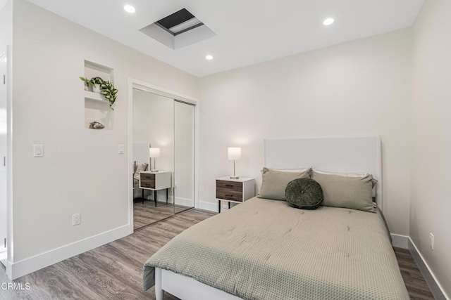 15233 Camarillo St, Sherman Oaks, CA 91403 - bedroom featuring wood finished floors, a closet, baseboards, and recessed lighting
