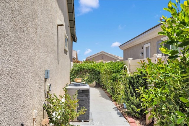 19423 Crystal Springs Ln, Apple Valley, CA 92308 - view of side of home with stucco siding and central AC unit
